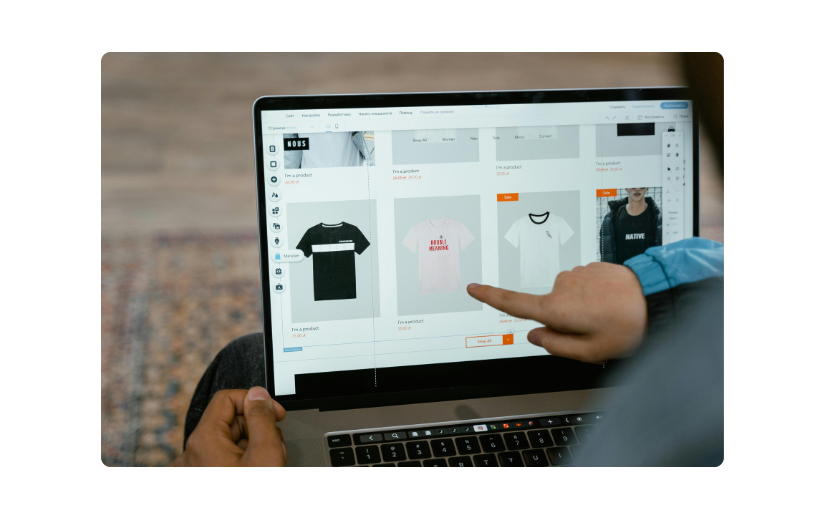 Person browsing an online store on a laptop, selecting t-shirts—ideal for learning how to sell on eBay as a beginner.